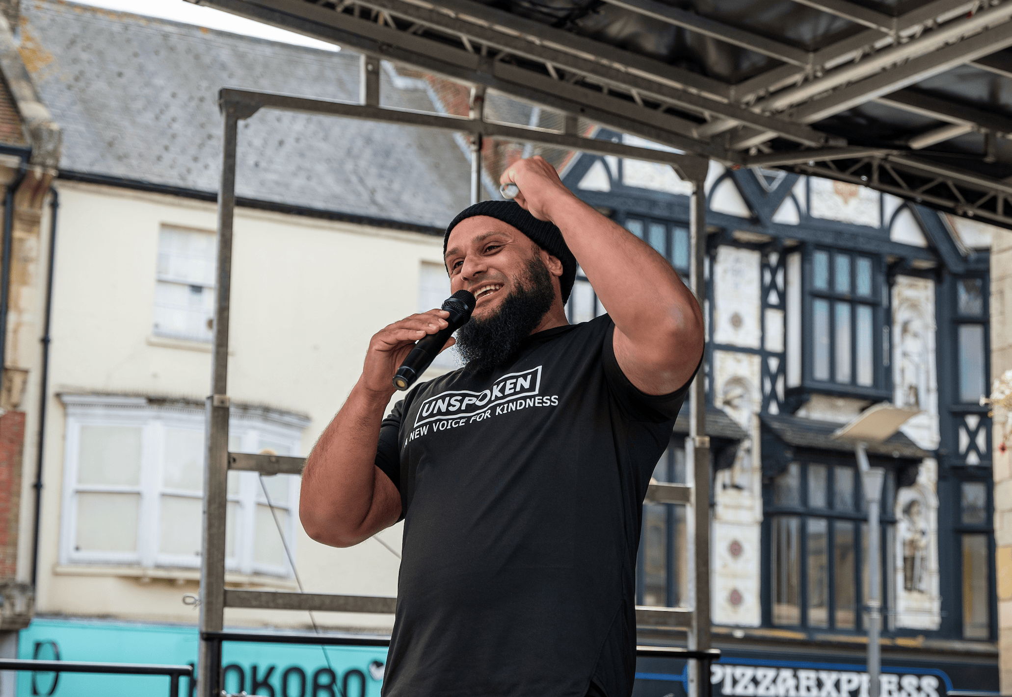 Atiq speaking at a public event in Peterborough.